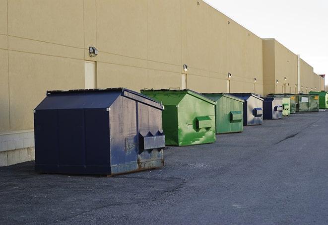 multiple construction dumpsters at a worksite holding various types of debris in Centerville, GA